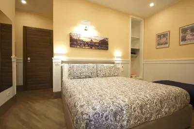a bedroom with a large bed in a room at Chez Noel in Rome