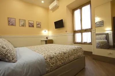 a bedroom with a bed and a window at Chez Noel in Rome