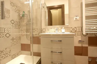 a bathroom with a shower and a sink and a mirror at Chez Noel in Rome