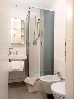a bathroom with a shower and a sink and a toilet at Caprareccia Apartment in Rome