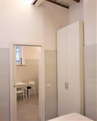 a room with a mirror and a table and a table at Caprareccia Apartment in Rome
