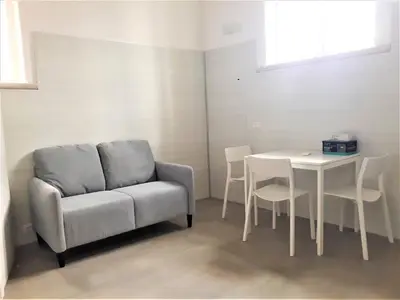 a living room with a couch and a table at Caprareccia Apartment in Rome