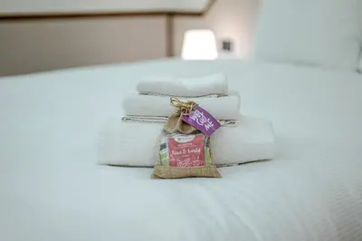 a pile of towels sitting on top of a bed at Restart Accommodations Pantheon in Rome