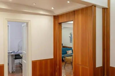 a hallway with a wooden door leading into a room at Restart Accommodations Pantheon in Rome