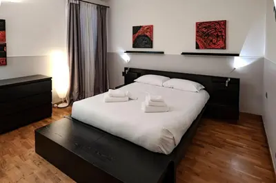 a bedroom with a large bed with two towels on it at Restart Accommodations Dea Roma in Rome