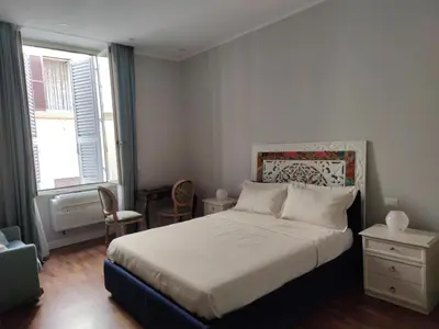 a bedroom with a large bed and a window at Magic Artisti in Rome