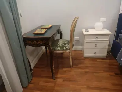 a desk with a chair and a dresser in a room at Magic Artisti in Rome