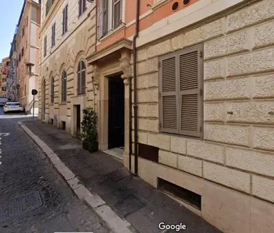 an empty street next to a building with a window at Magic Artisti in Rome