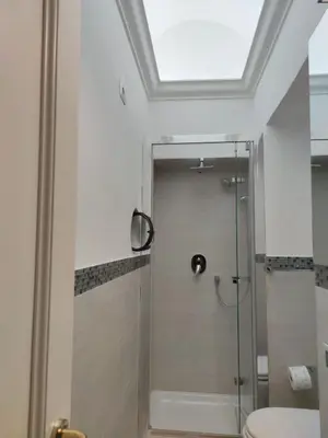 a shower with a glass door in a bathroom at Magic Artisti in Rome