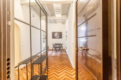 a hallway with a table and chairs and a door at Navona Urban Sanctuary in Rome