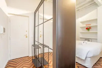 a bedroom with a mirror next to a bed at Navona Urban Sanctuary in Rome