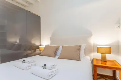 a bedroom with a white bed with towels on it at Navona Urban Sanctuary in Rome