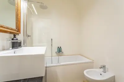 a white bathroom with a tub and a sink at Navona Urban Sanctuary in Rome