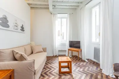 a living room with a couch and a tv at Navona Urban Sanctuary in Rome