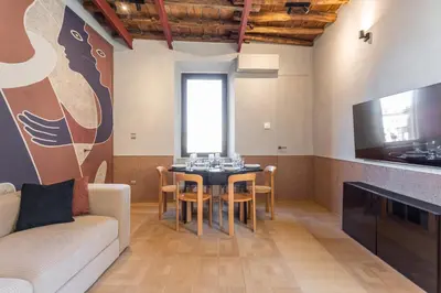 a living room with a table and a couch at Spanish Steps Exclusive 3BDR in Rome