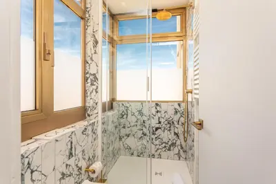a bathroom with a shower and a window at Spanish Steps Exclusive 3BDR in Rome