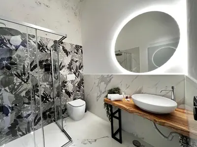 a bathroom with a sink and a mirror at ESE luxury spa suites - Private Jacuzzi Rooms Near Termini, Perfect for Winter in Rome