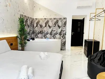 a bathroom with a bath tub and a bed at ESE luxury spa suites - Private Jacuzzi Rooms Near Termini, Perfect for Winter in Rome