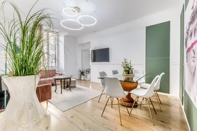 a living room with a table and white chairs at CdR 190 - Vaticano in Rome