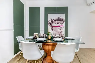 a dining room with a glass table and white chairs at CdR 190 - Vaticano in Rome