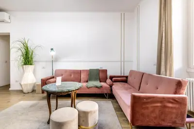a living room with a pink couch and a table at CdR 190 - Vaticano in Rome