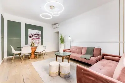 a living room with a pink couch and a table at CdR 190 - Vaticano in Rome