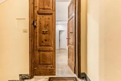 a hallway with a wooden door in a house at CdR 190 - Vaticano in Rome