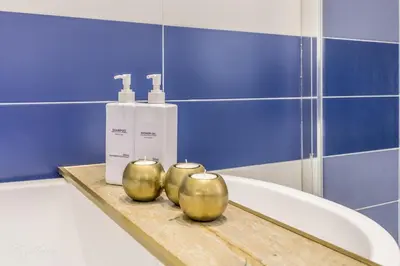 a bathroom with a tub and two candles on a counter at CdR 190 - Vaticano in Rome