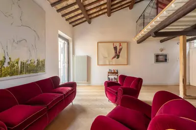 a living room with red couches and a painting at Monti Designer Loft by Romeloft in Rome