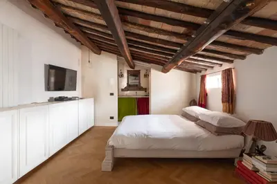 a bedroom with a white bed and a television at Monti Designer Loft by Romeloft in Rome