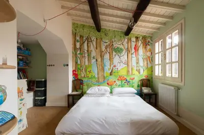 a bedroom with a large bed with a tree mural at Monti Designer Loft by Romeloft in Rome