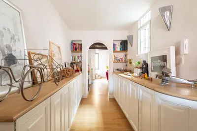 a kitchen with a long counter with books at Monti Designer Loft by Romeloft in Rome
