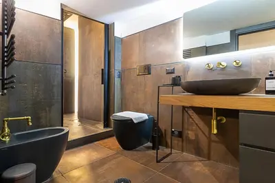 a bathroom with two sinks and a tub and a toilet at Luxury Loft Campo Dè Fiori in Rome