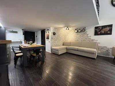 a living room with a couch and a table at Luxury Loft Campo Dè Fiori in Rome