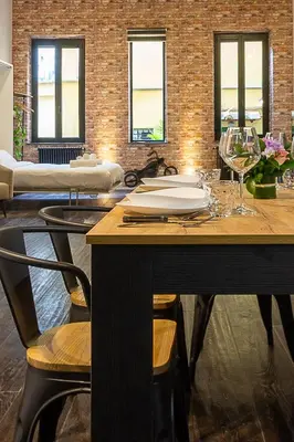 a dining room with a table with wine glasses at Luxury Loft Campo Dè Fiori in Rome