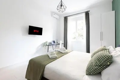 a white bedroom with a bed with towels on it at Lucky's House - 400mt to Metro A, 3 bedrooms, 6-8 pax, A-C, Roma in Rome