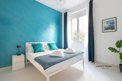 a blue bedroom with a bed with towels on it at Lucky's House - 400mt to Metro A, 3 bedrooms, 6-8 pax, A-C, Roma in Rome
