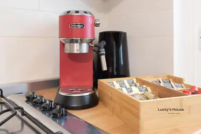 a red mixer sitting on a counter next to a wooden box at Lucky's House - 400mt to Metro A, 3 bedrooms, 6-8 pax, A-C, Roma in Rome