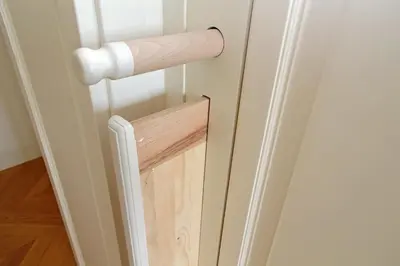 a roll of toilet paper hanging on a door at Vatican Basilica Apartment in Rome