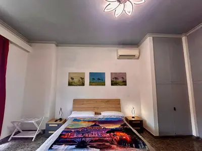 a bedroom with a bed with a painting on the wall at La casa di Ezechiele in Rome