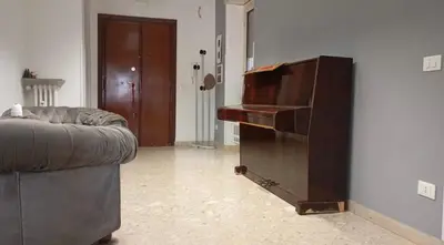 a piano in a living room with a couch at La casa di Ezechiele in Rome