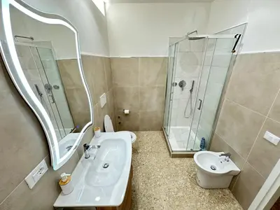 a bathroom with a sink and a shower and a toilet at La casa di Ezechiele in Rome