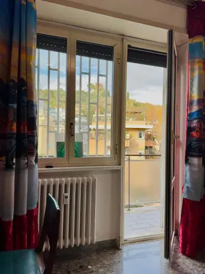 a room with a window with a view of a building at La casa di Ezechiele in Rome