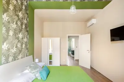 a living room with a couch and a green rug at San Giovanni Living House 2 in Rome