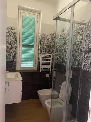 a bathroom with a shower and a toilet and a sink at San Giovanni Living House 2 in Rome