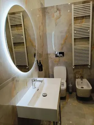 a bathroom with a sink and a toilet and a mirror at Cozy Luxury room San Pietro in Rome