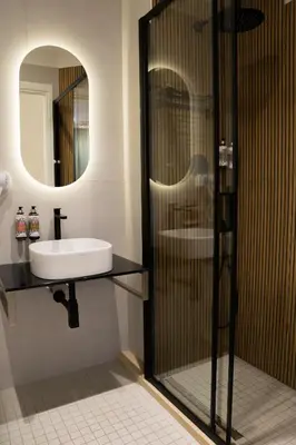 a bathroom with a sink and a mirror at Lilla Suites - Musei Vaticani in Rome