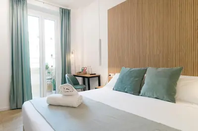 a bedroom with a bed with a towel on it at Lilla Suites - Musei Vaticani in Rome