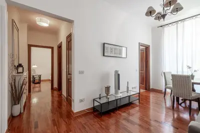 a living room with a television and a table at La Tua Casa al Colosseo in Rome