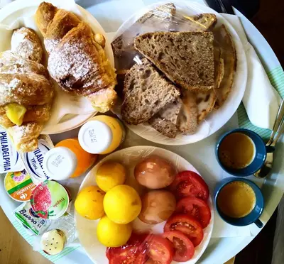 a plate of food with bread and fruit on a table at GH Lorvand in Rome
